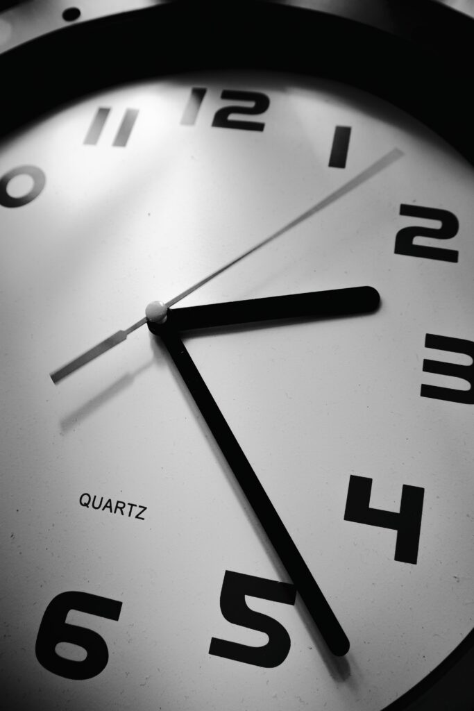 Detailed black and white photo of a quartz clock face showing precise time.
